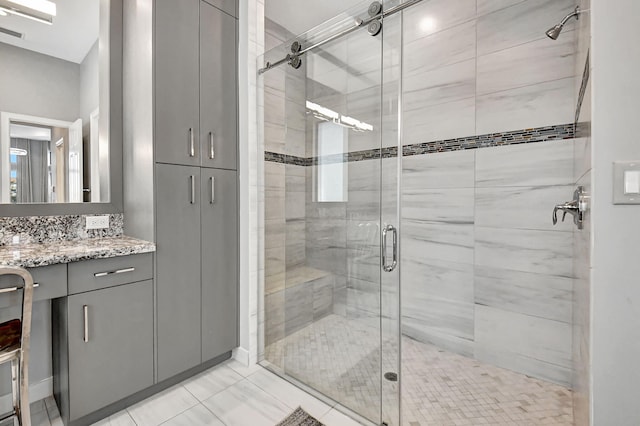 bathroom featuring walk in shower, tile flooring, and vanity