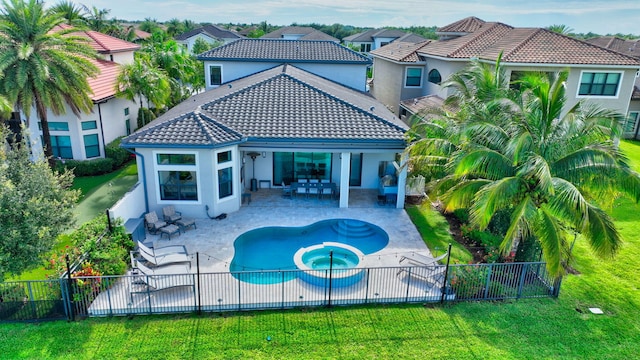 rear view of property with a patio, outdoor lounge area, an in ground hot tub, and a lawn