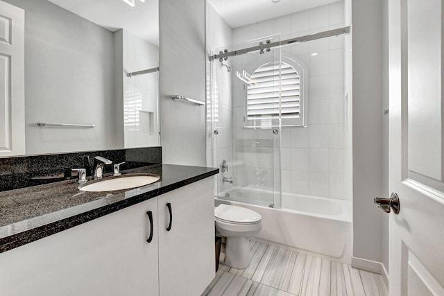 full bathroom featuring tile flooring, toilet, tiled shower / bath combo, and large vanity