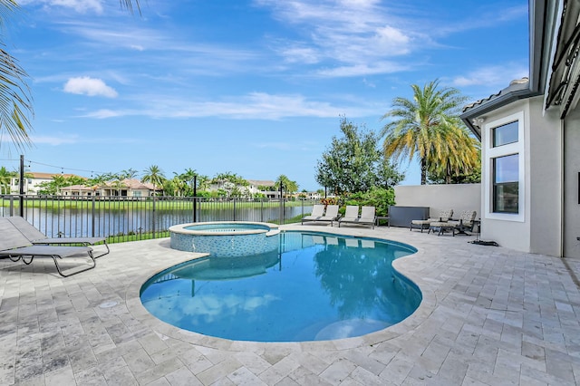 view of swimming pool featuring a patio and an in ground hot tub