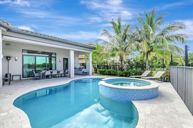 view of swimming pool featuring a patio area and an in ground hot tub