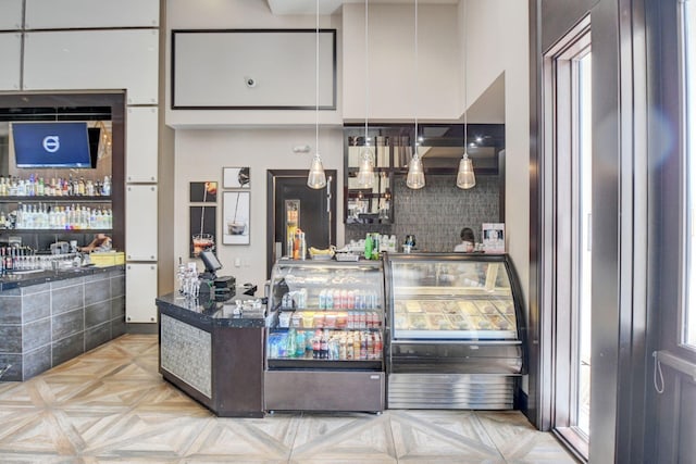 kitchen featuring a high ceiling and light parquet flooring