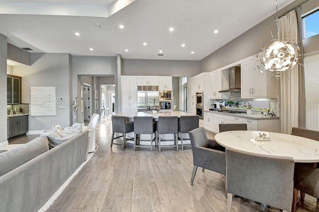 dining space with sink and light hardwood / wood-style flooring