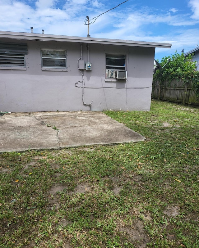 rear view of house featuring a yard and a patio area