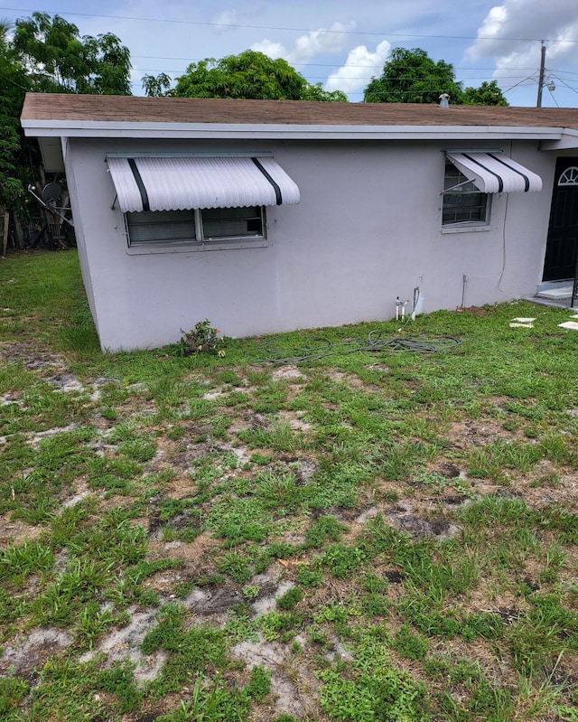 view of side of property with a lawn