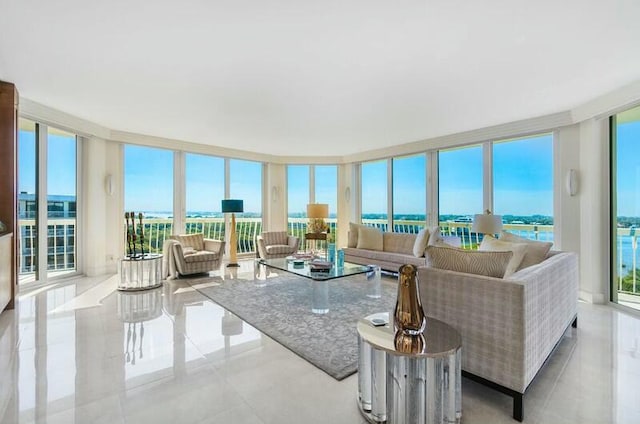 living room with a water view and a wall of windows