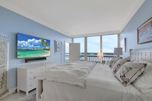 bedroom with access to exterior, a wall of windows, and ornamental molding