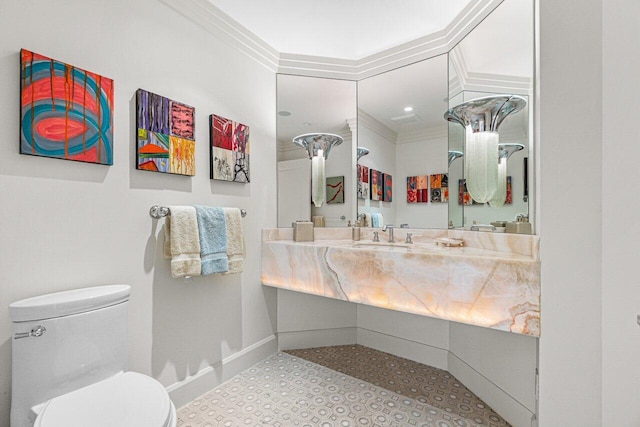 bathroom with vanity, ornamental molding, and toilet