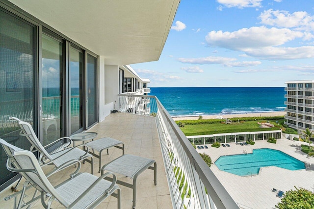 balcony with a beach view and a water view