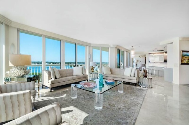 living room featuring floor to ceiling windows and a water view