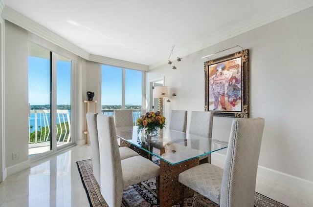 dining room featuring crown molding, a water view, and plenty of natural light