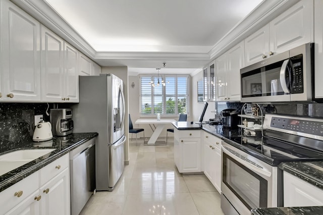 kitchen featuring white cabinetry, a chandelier, and appliances with stainless steel finishes