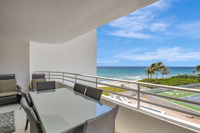 balcony with a view of the beach and a water view