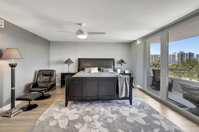 bedroom with ceiling fan, light hardwood / wood-style floors, and access to outside