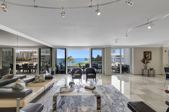 living room featuring floor to ceiling windows and ornamental molding