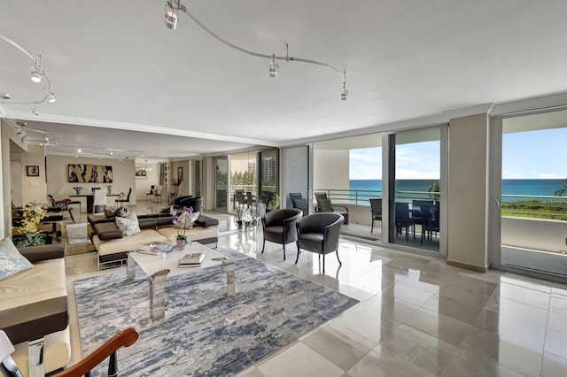 tiled living room featuring a water view and a wall of windows