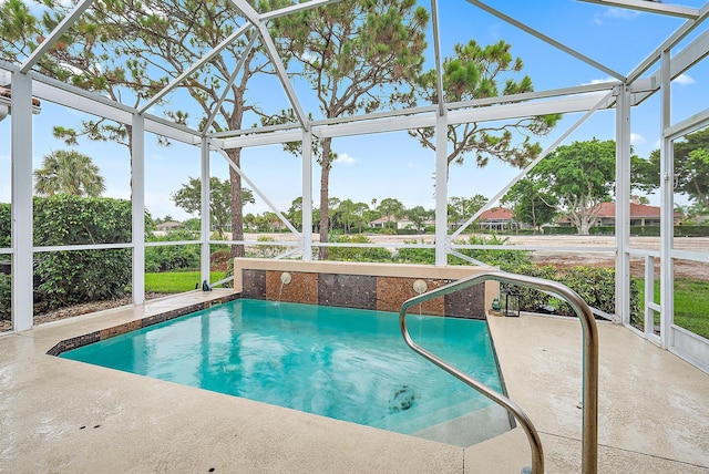 view of swimming pool featuring a lanai and a patio