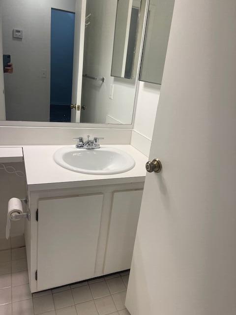 bathroom featuring tile patterned flooring and vanity