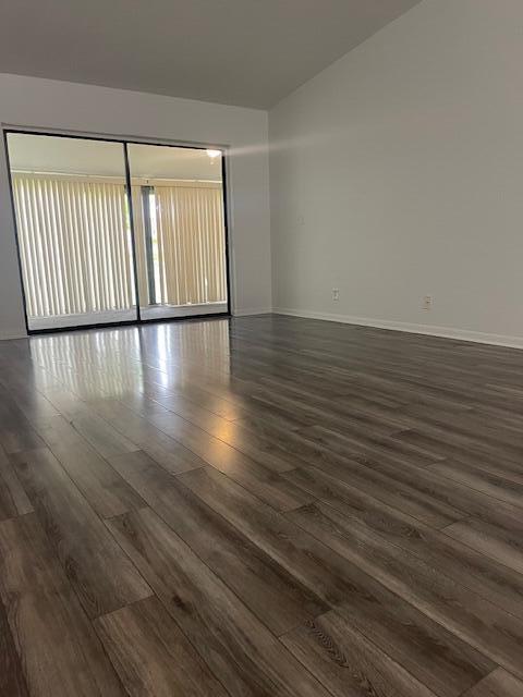 empty room featuring dark wood-type flooring