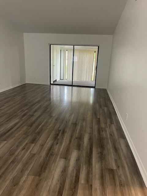 unfurnished room with dark hardwood / wood-style floors