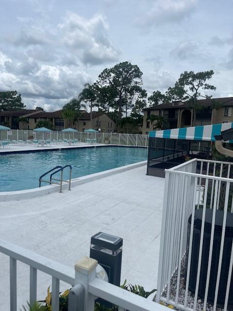 view of pool with a patio and cooling unit