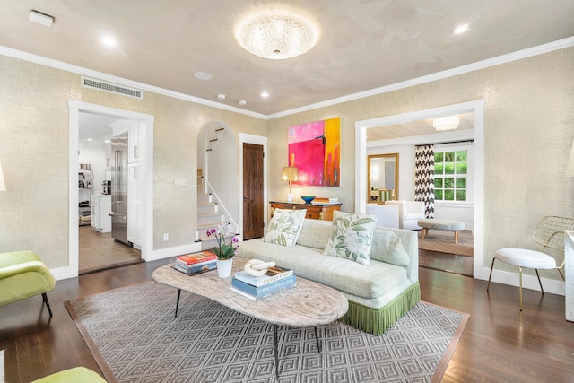 living room with dark wood-type flooring and ornamental molding