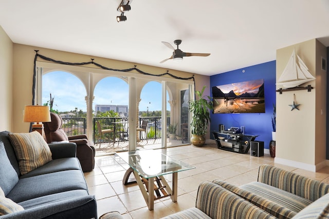 living room with ceiling fan and light tile patterned floors