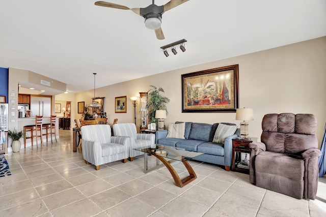 living room with light tile patterned floors, ceiling fan, and visible vents