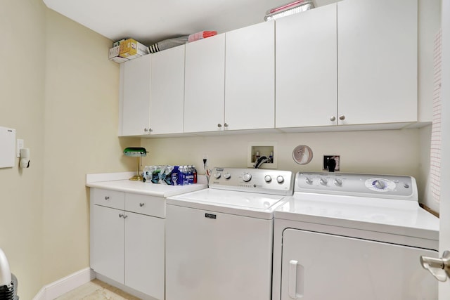 laundry room with independent washer and dryer, cabinet space, and baseboards