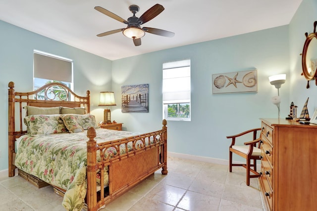 bedroom featuring ceiling fan and baseboards