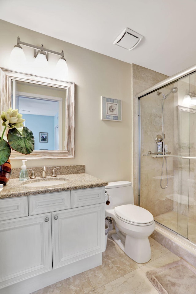 bathroom with toilet, a shower stall, visible vents, and vanity