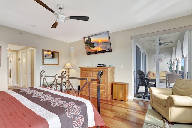 bedroom with hardwood / wood-style floors, ceiling fan, and access to outside