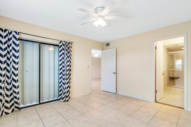 unfurnished bedroom with ensuite bathroom, ceiling fan, and light tile patterned flooring