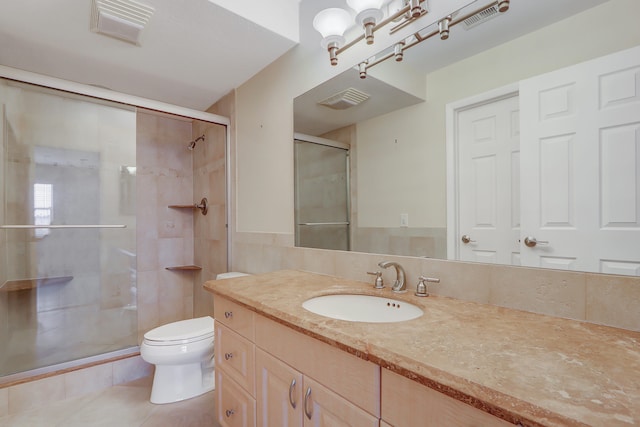 bathroom with decorative backsplash, tile patterned floors, vanity, a shower with door, and toilet