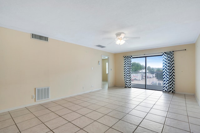 spare room featuring light tile patterned floors, ceiling fan, and crown molding