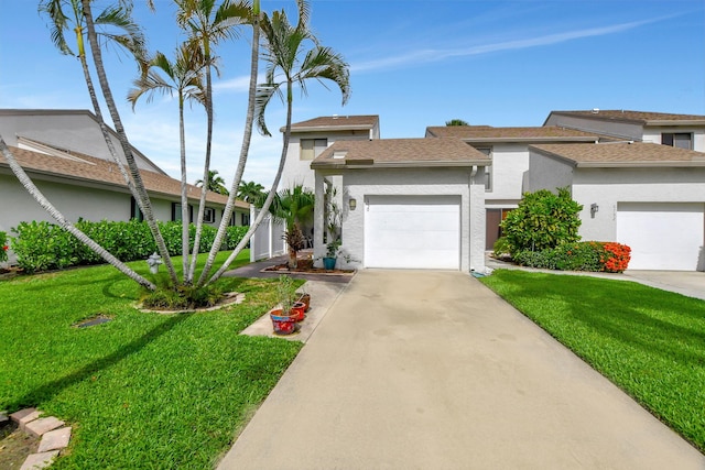 view of front of home with a garage and a front lawn