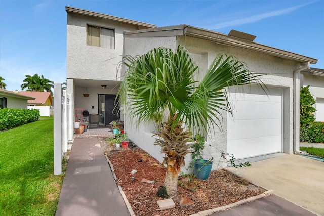 view of front of property with a garage and a front yard