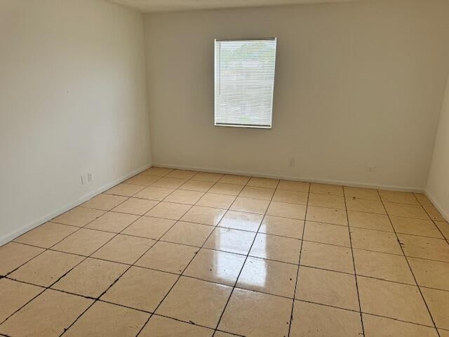 unfurnished room featuring light tile flooring