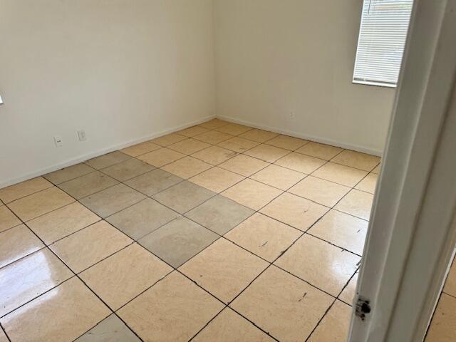 empty room featuring light tile floors