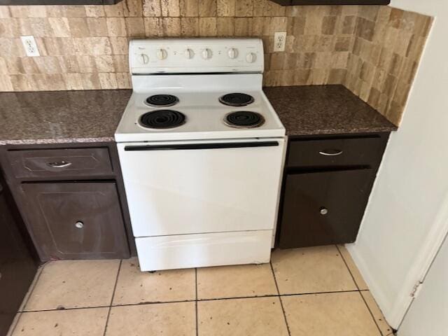 kitchen with dark brown cabinetry, electric range, and light tile floors