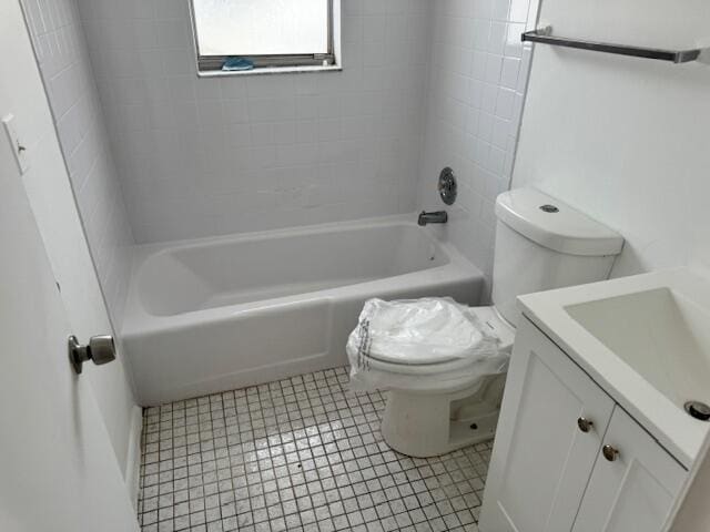 full bathroom featuring tiled shower / bath combo, tile flooring, toilet, and vanity