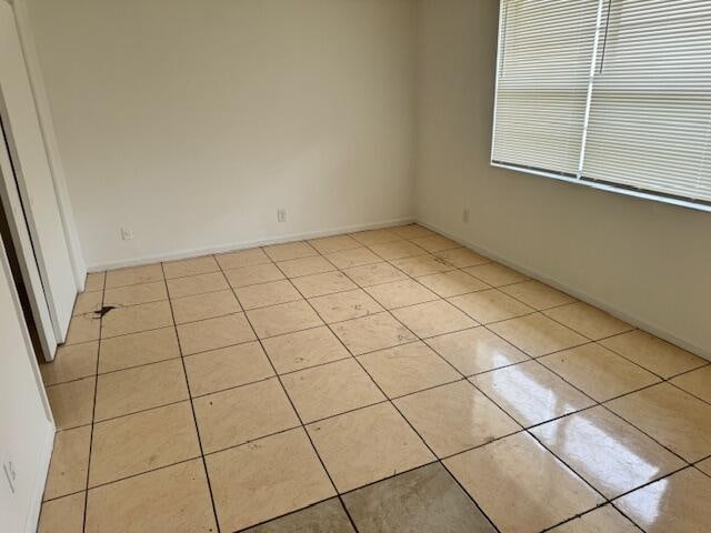 empty room with light tile floors