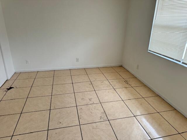 unfurnished room with light tile floors