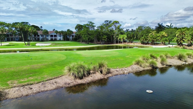 view of property's community with a water view and a yard