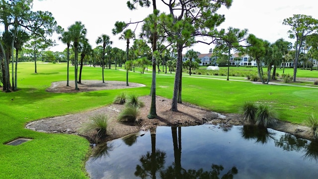 view of property's community featuring a lawn and a water view