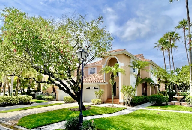 mediterranean / spanish-style house with a front yard