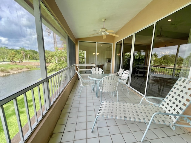 sunroom with ceiling fan and lofted ceiling