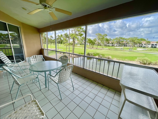 unfurnished sunroom with ceiling fan