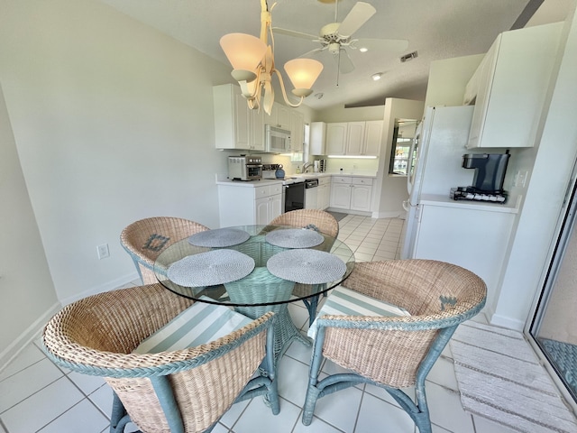 dining room featuring ceiling fan, light tile patterned floors, sink, and vaulted ceiling