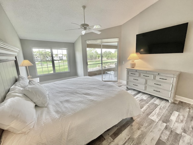 bedroom with light wood-type flooring, a textured ceiling, access to outside, ceiling fan, and lofted ceiling